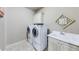 Convenient laundry room with washer, dryer, sink, and storage cabinets at 5925 Boulder Bluff Dr, Cumming, GA 30040