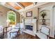 Cozy living room features a fireplace with built-in shelving and large arched windows with natural light at 5925 Boulder Bluff Dr, Cumming, GA 30040