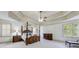 Spacious main bedroom features trey ceiling, decorative windows, and dark wood furniture at 5925 Boulder Bluff Dr, Cumming, GA 30040