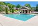 A spacious community pool with a covered pool house and well-kept, concrete pool deck at 5925 Boulder Bluff Dr, Cumming, GA 30040