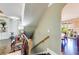 Traditional staircase leads to a foyer with built-in shelving and dining area at 5925 Boulder Bluff Dr, Cumming, GA 30040