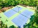 Brightly lit tennis courts featuring green surfacing and blue inbounds at 5925 Boulder Bluff Dr, Cumming, GA 30040