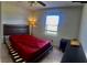 Includes a bed with a red sheet, a ceiling fan, and an exterior window at 750 Dalrymple Rd # G3, Atlanta, GA 30328