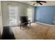 Contains two windows, a ceiling fan, a blue accent wall, and neutral carpet at 750 Dalrymple Rd # G3, Atlanta, GA 30328