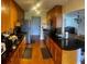 Reveals granite counters, wood cabinets, stainless appliances, hardwood floors, and access to the living room at 750 Dalrymple Rd # G3, Atlanta, GA 30328