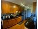 Features light wood cabinetry, dark countertops, stainless steel appliances, and wood flooring at 750 Dalrymple Rd # G3, Atlanta, GA 30328