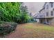 Large and verdant backyard offering a lush green setting for outdoor enjoyment and relaxation at 1912 Riverton Dr, Suwanee, GA 30024