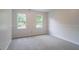 Bright bedroom with neutral carpet and wainscoting detail, offering a cozy atmosphere at 1912 Riverton Dr, Suwanee, GA 30024