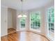 Bright dining area featuring hardwood floors and large windows overlooking lush greenery at 1912 Riverton Dr, Suwanee, GA 30024