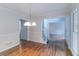 Spacious dining area with hardwood floors, connecting to the hallway and stairs at 1912 Riverton Dr, Suwanee, GA 30024