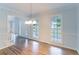 Light-filled dining area featuring hardwood floors and classic chandelier at 1912 Riverton Dr, Suwanee, GA 30024