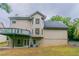 Two-story home features a private deck above a covered patio and large, light-filled windows at 1912 Riverton Dr, Suwanee, GA 30024