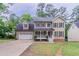 Charming two-story home with a manicured front yard and a two-car garage at 1912 Riverton Dr, Suwanee, GA 30024