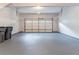 A two car garage with concrete floor and plenty of storage space at 1912 Riverton Dr, Suwanee, GA 30024