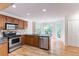 Traditional kitchen with wood cabinets, stainless steel appliances, and granite countertops at 1912 Riverton Dr, Suwanee, GA 30024