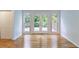 Bright living room with hardwood floors, double doors that lead to a rear deck at 1912 Riverton Dr, Suwanee, GA 30024