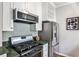 Well-equipped kitchen with stainless steel appliances, a gas range, and stylish backsplash at 318 Glenwood Se Ave, Atlanta, GA 30312