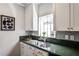Kitchen showcasing stainless steel sink, white cabinets, and ample natural light at 318 Glenwood Se Ave, Atlanta, GA 30312