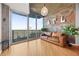 Bright living room featuring hardwood floors, brick accent wall with industrial accents and balcony access at 400 W Peachtree Nw St # 3614, Atlanta, GA 30308