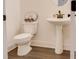 Bathroom with toilet, pedestal sink, neutral decor and modern fixtures at 7621 Avalon Blvd, Fairburn, GA 30213