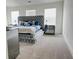 A spacious bedroom with a large tufted bed, mirrored accents, and ample natural light at 7621 Avalon Blvd, Fairburn, GA 30213