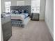 Stylish bedroom featuring a large bed with a tufted headboard and mirrored nightstands at 7621 Avalon Blvd, Fairburn, GA 30213