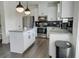 Bright and modern kitchen with stainless steel appliances, granite countertops and hardwood floors at 7621 Avalon Blvd, Fairburn, GA 30213