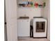 Convenient laundry room featuring a washer and dryer with ample shelving for storage at 7621 Avalon Blvd, Fairburn, GA 30213