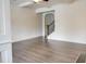 Spacious living room with beamed ceilings, hardwood floors and neutral color palette at 7621 Avalon Blvd, Fairburn, GA 30213