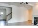 Bright living room with a fireplace, open staircase, and neutral color palette at 7621 Avalon Blvd, Fairburn, GA 30213