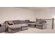 A comfortable seating area in a loft space, featuring an oversized sectional sofa and a chair at 7621 Avalon Blvd, Fairburn, GA 30213