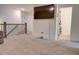 A cozy loft space with a large screen TV, carpet flooring, and access to a bathroom at 7621 Avalon Blvd, Fairburn, GA 30213