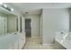 Bathroom featuring a dual sink vanity and separate tub at 981 Charles Hall Dr, Dacula, GA 30019