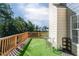 Outdoor deck with artificial grass, a small table, and seating, perfect for relaxing at 981 Charles Hall Dr, Dacula, GA 30019