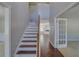 Bright foyer with hardwood floors, a staircase, and views of other rooms in the home at 981 Charles Hall Dr, Dacula, GA 30019