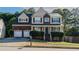Charming two-story home with a brick facade, a two-car garage, and manicured landscaping at 981 Charles Hall Dr, Dacula, GA 30019