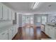 Open kitchen with white cabinetry, stainless appliances, and sunlit breakfast nook at 981 Charles Hall Dr, Dacula, GA 30019