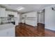 Bright kitchen featuring white cabinets, stainless steel appliances, and hardwood floors at 981 Charles Hall Dr, Dacula, GA 30019