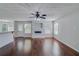 Open-concept living room with hardwood floors, a fireplace, and ample natural light at 981 Charles Hall Dr, Dacula, GA 30019