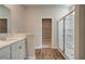 Bathroom featuring single sink vanity, wood floor, and glass enclosed shower at 288 Abbotts Crossing Cir, Conyers, GA 30094