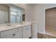 Bright bathroom featuring double sink vanity, large mirror, and separate closet and toilet areas at 288 Abbotts Crossing Cir, Conyers, GA 30094