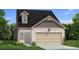 Charming two-story home with light brick, complemented by a two-car garage and a well-maintained lawn at 288 Abbotts Crossing Cir, Conyers, GA 30094