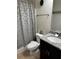 Bathroom with a granite countertop vanity and patterned shower curtain at 4858 Stratford Ln, Johns Creek, GA 30022