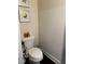 Half bathroom with decorative accents, a toilet, and dark wood floors at 4858 Stratford Ln, Johns Creek, GA 30022
