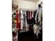 Walk-in closet with metal shelving and hanging clothes at 4858 Stratford Ln, Johns Creek, GA 30022
