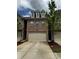 Beautiful brick townhome features a two-car garage and well-maintained landscaping at 4858 Stratford Ln, Johns Creek, GA 30022