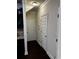 Hallway featuring dark hardwood floors and white doors at 4858 Stratford Ln, Johns Creek, GA 30022