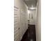 Bright hallway featuring hardwood floors, white doors, and stylish decorative mirrors at 4858 Stratford Ln, Johns Creek, GA 30022
