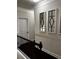 Upstairs hallway featuring decorative framed art, dark hardwood flooring, and white trim at 4858 Stratford Ln, Johns Creek, GA 30022