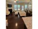 Bright living room featuring a fireplace, hardwood floors, and an open concept to the kitchen and dining area at 4858 Stratford Ln, Johns Creek, GA 30022